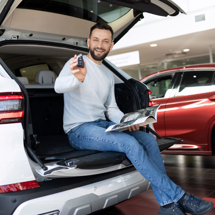a satisfied customer demonstrates the keys of a new SUV.